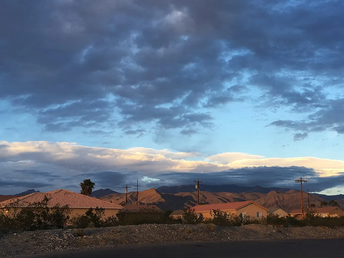 Homes in Pahrump at sunset with the Spring Mountains behind them.